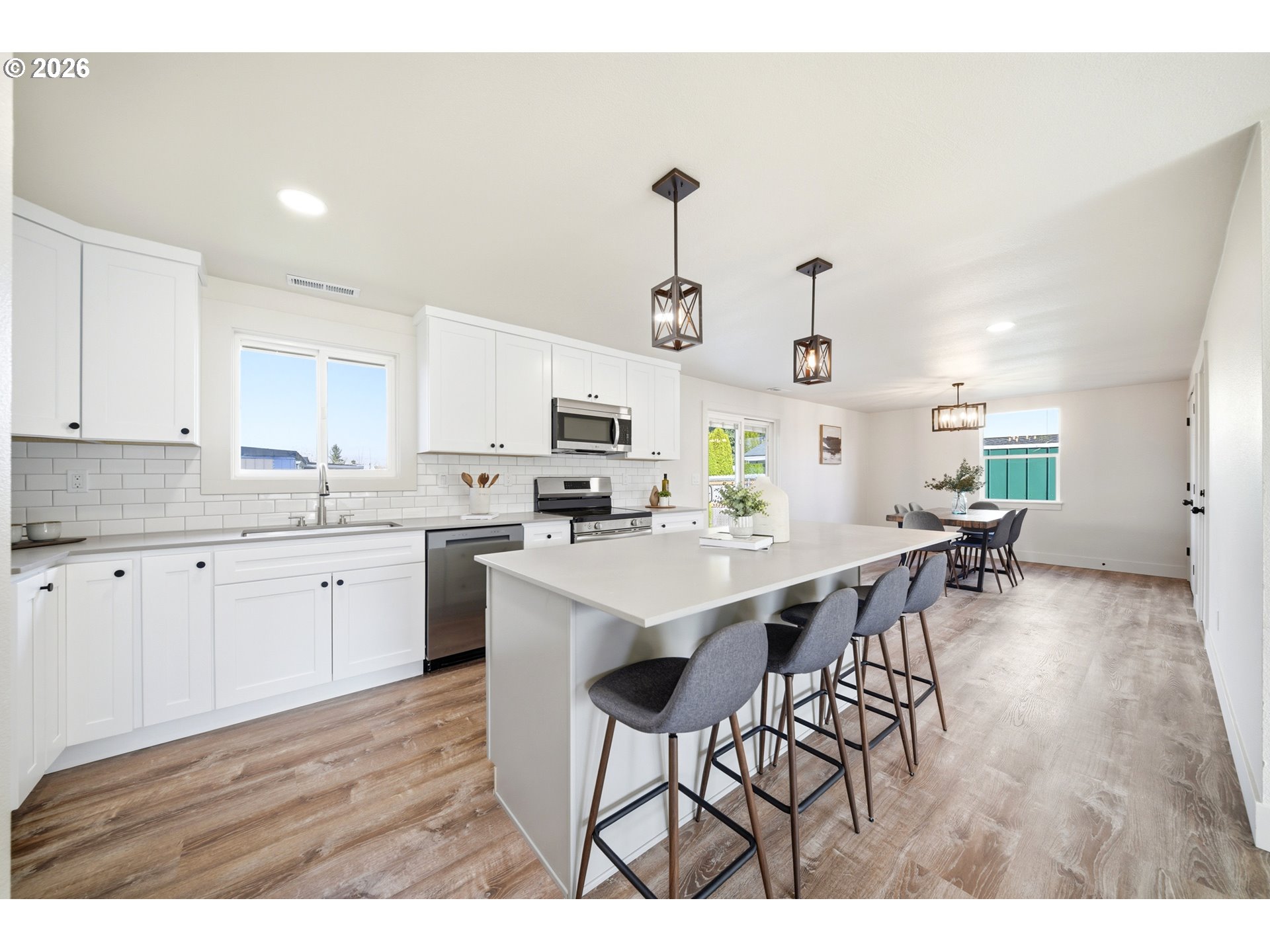 879 North Broadway Street Estacada, OR 97023 - Photo 9 of 37 a kitchen with stainless steel appliances kitchen island granite countertop a table chairs sink and cabinets