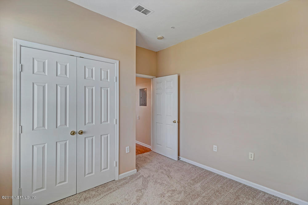 7990 Baymeadows Road East, Unit 211 Jacksonville, FL 32256 - Photo 17 of 21 an empty room with a door