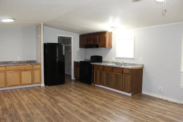 a kitchen with a refrigerator and a sink