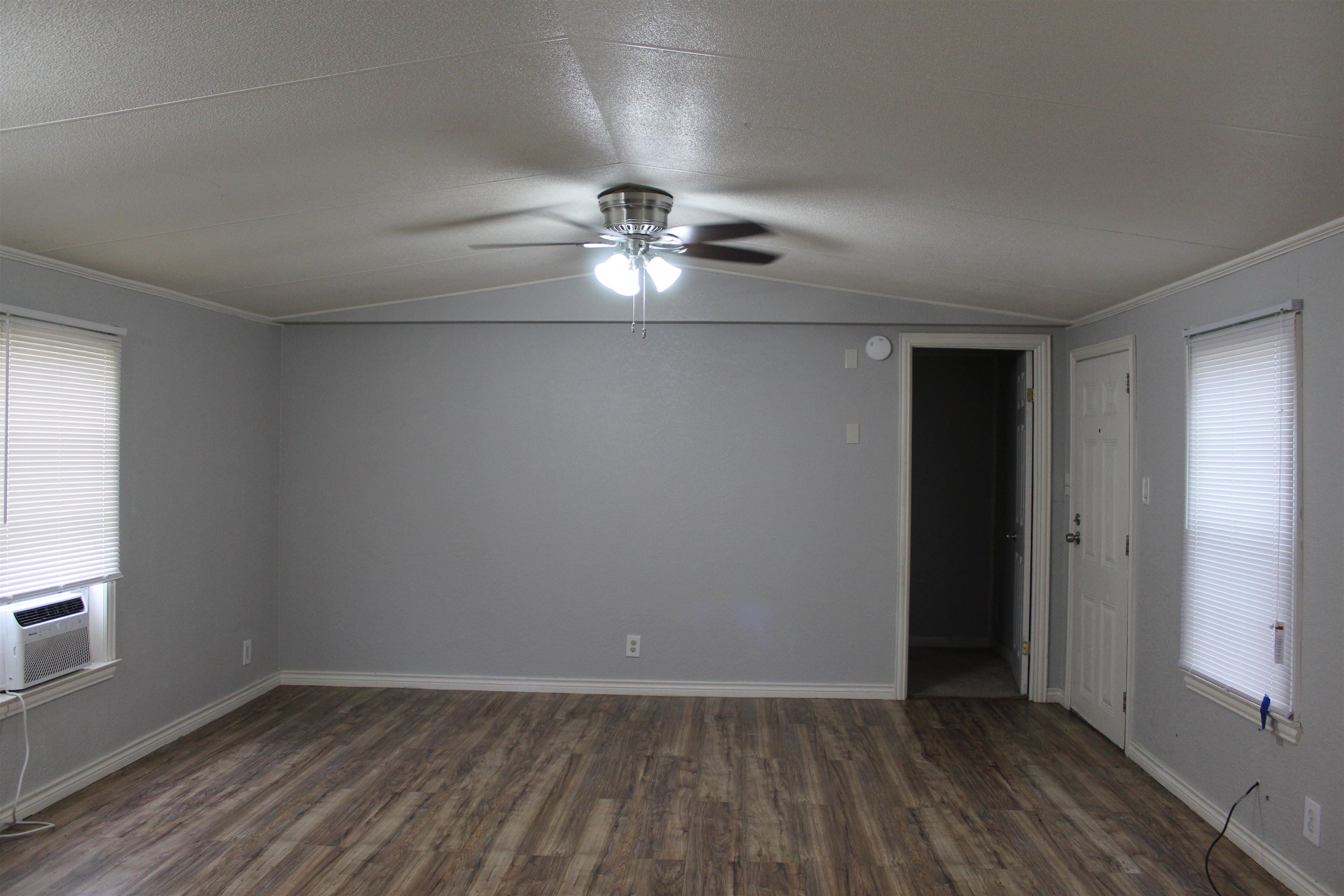 919 Austin Street Kingsland, TX 78639 - Photo 5 of 7 wooden floor in an empty room with a window
