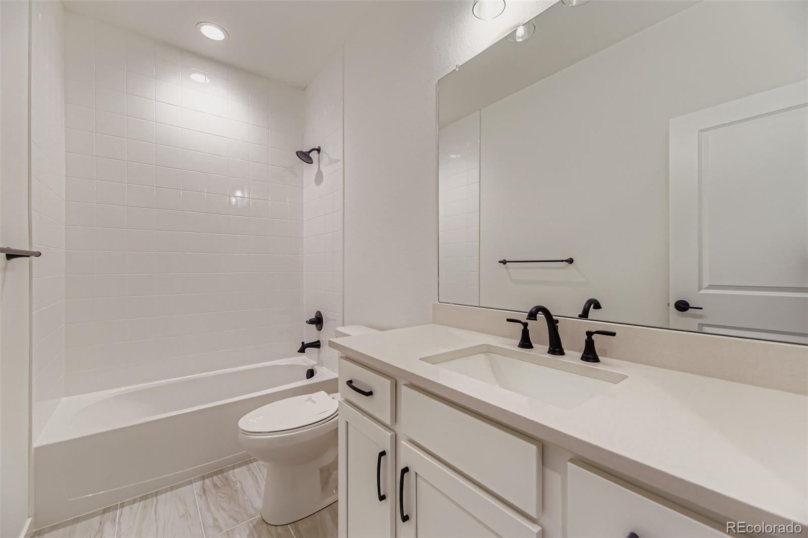 8905 South Riviera Way Aurora, CO 80016 - Photo 18 of 27 a bathroom with a sink a toilet and shower