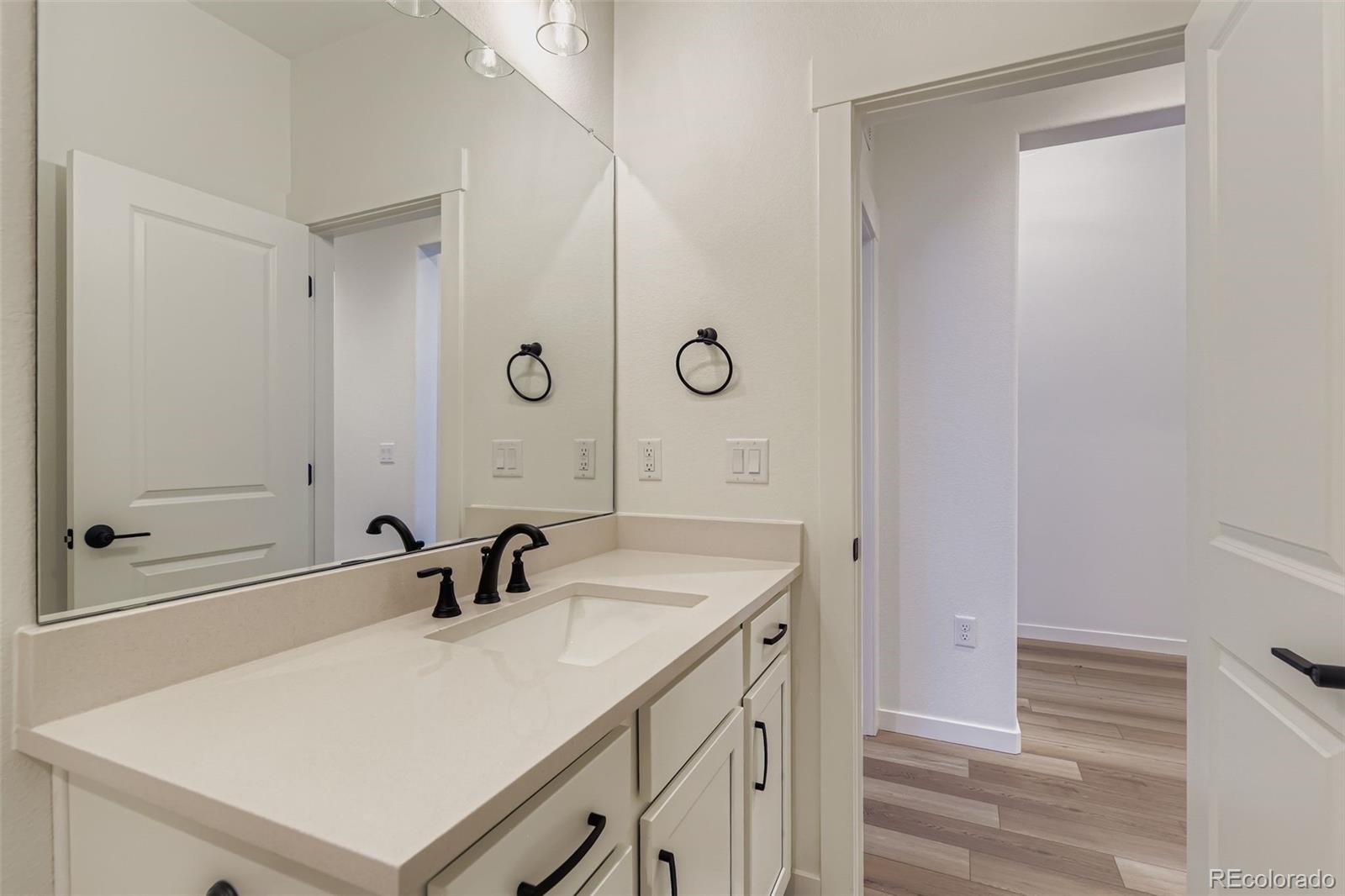 8905 South Riviera Way Aurora, CO 80016 - Photo 20 of 27 a bathroom with a sink and a mirror