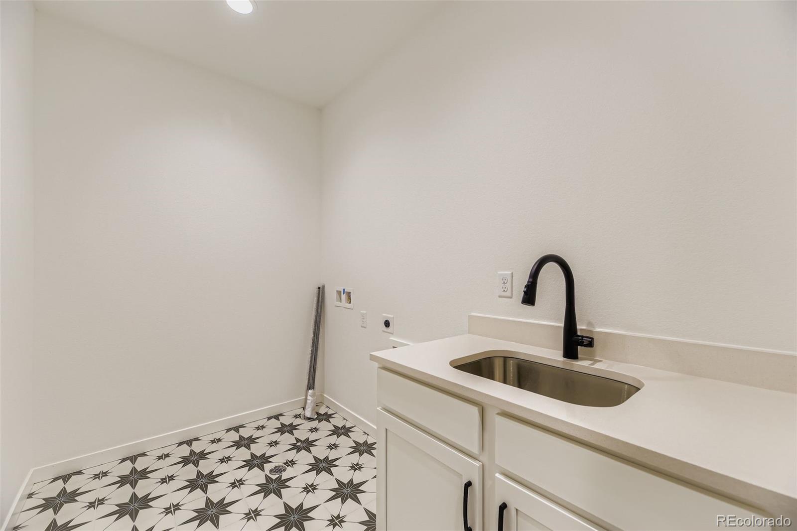 8905 South Riviera Way Aurora, CO 80016 - Photo 22 of 27 a close view of sink and tap