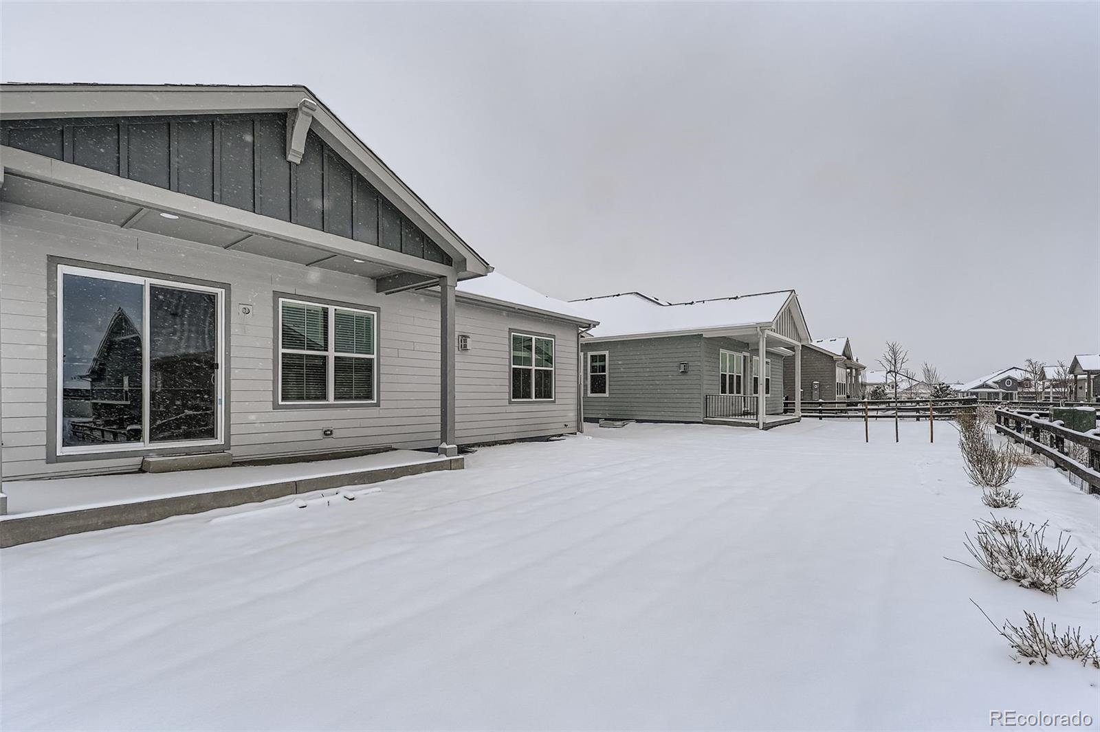 8905 South Riviera Way Aurora, CO 80016 - Photo 25 of 27 a front view of a house with a yard and garage