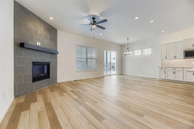 a view of an empty room with a window and fireplace