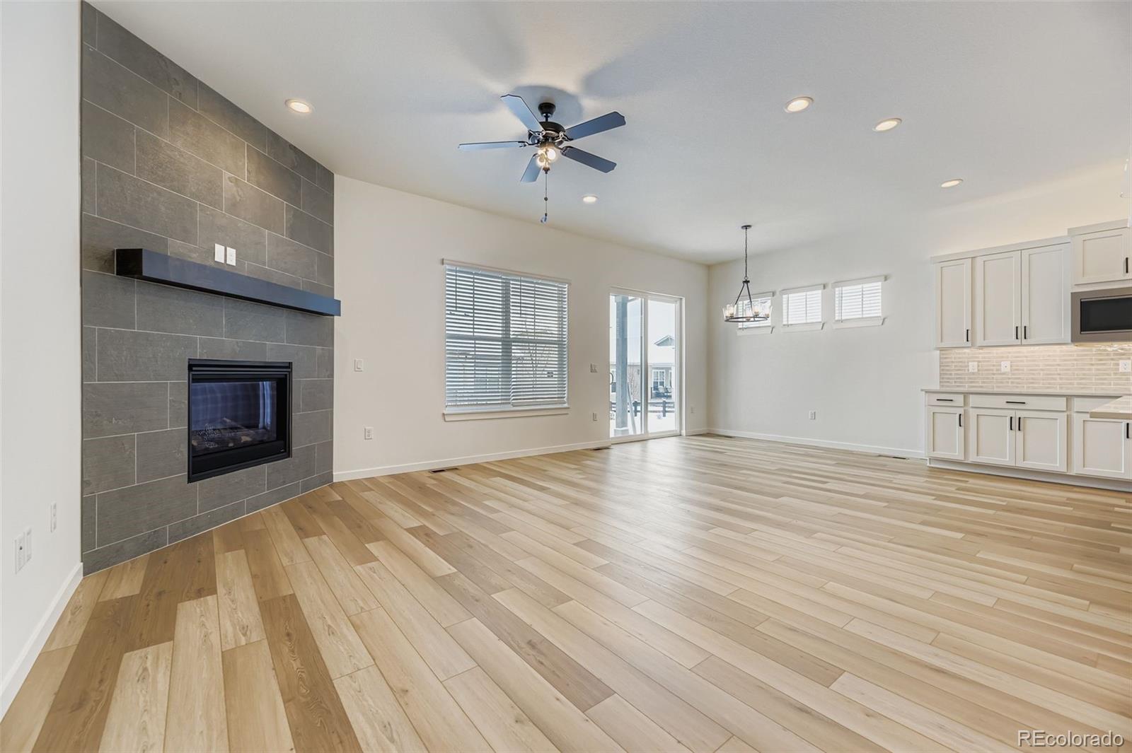 8905 South Riviera Way Aurora, CO 80016 - Photo 5 of 27 a view of an empty room with a window and fireplace