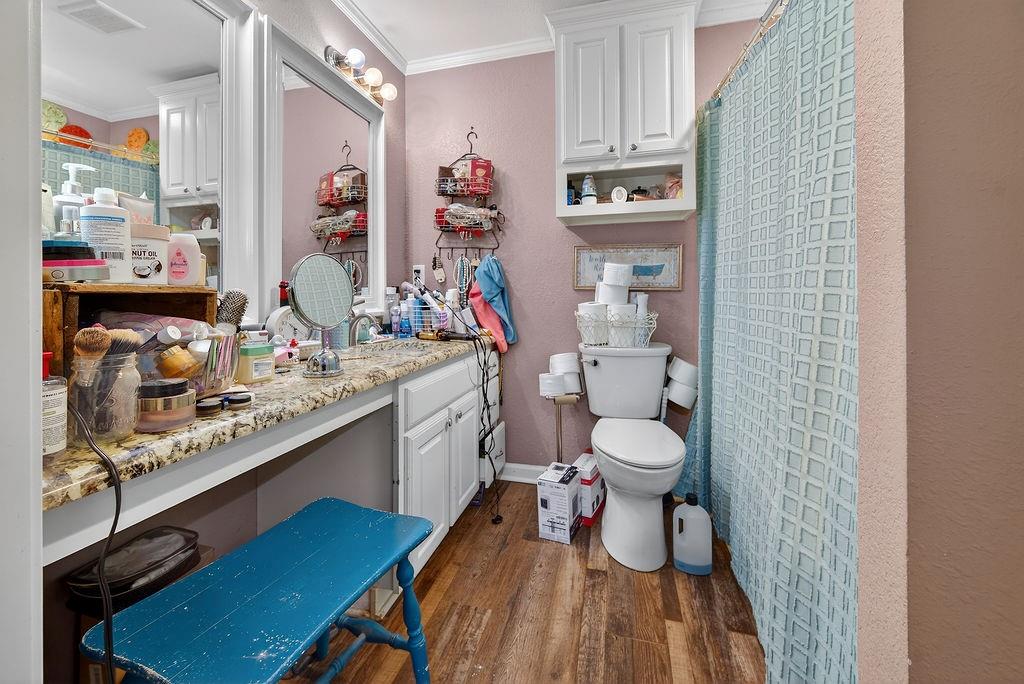 9474 Fm 804 Larue, TX 75770 - Photo 21 of 25 a bathroom with a granite countertop sink a toilet and a shower curtain