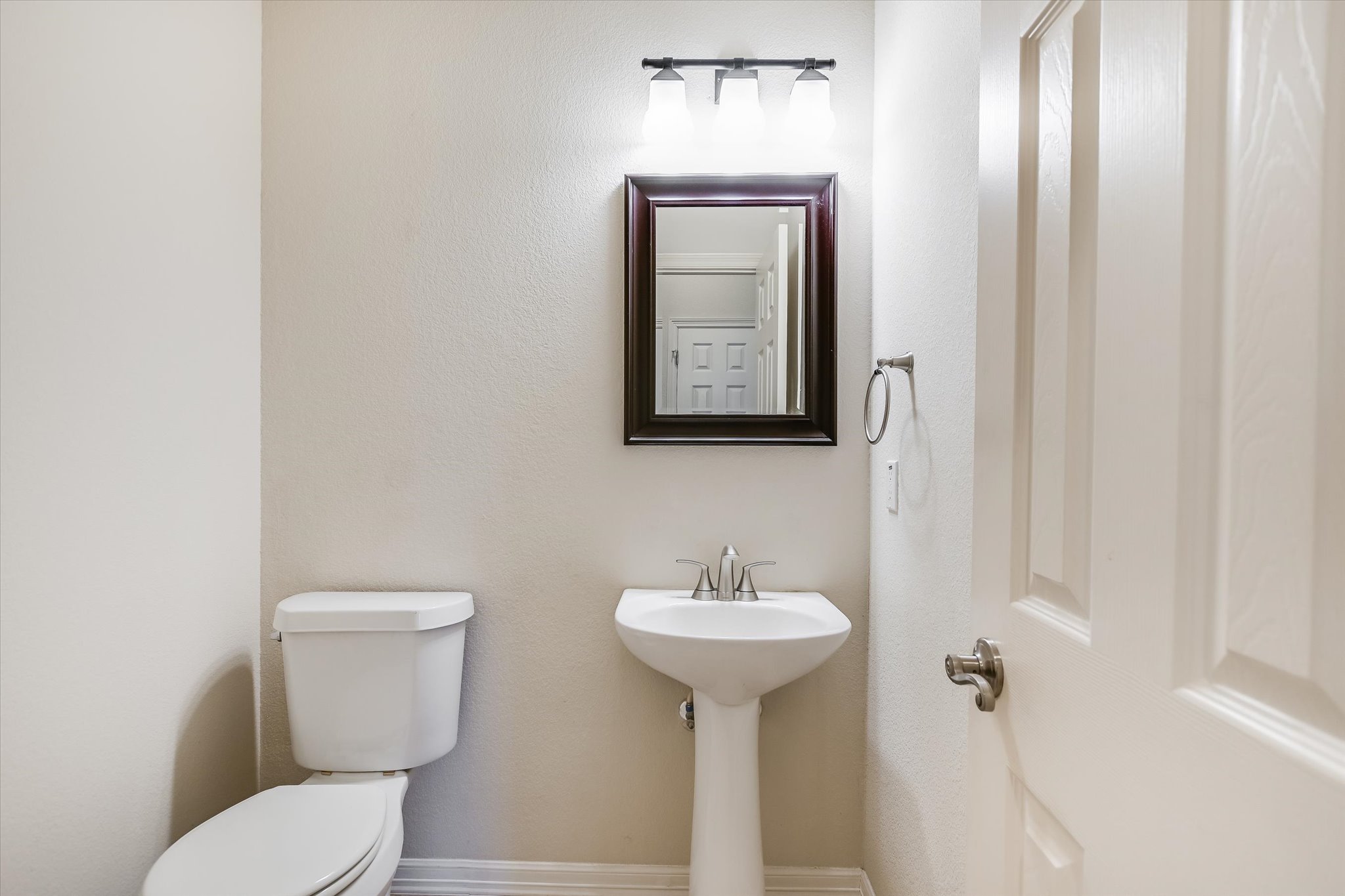 2300 Village View Loop Pflugerville, TX 78660 - Photo 15 of 25 a bathroom with a toilet sink and mirror