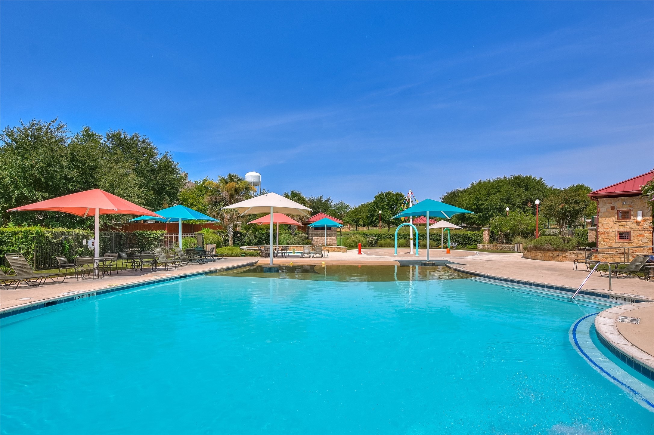 2300 Village View Loop Pflugerville, TX 78660 - Photo 20 of 25 a view of a swimming pool with lawn chairs under an umbrella