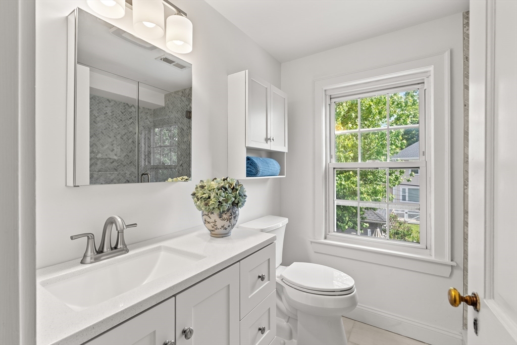 6 Shetland Road Marblehead, MA 01945 - Photo 22 of 39 a bathroom with a granite countertop sink toilet and a mirror