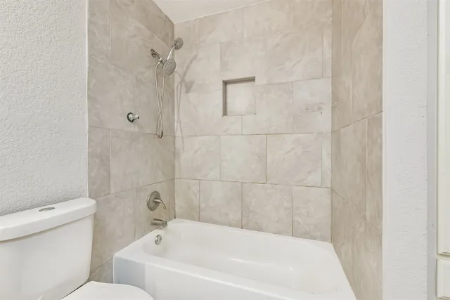 a bathroom with a bathtub and a toilet