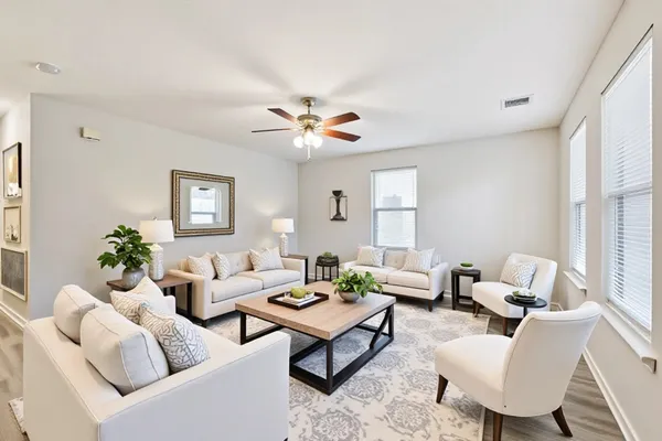 a living room with furniture a chandelier and a window