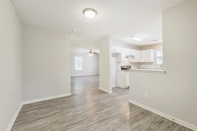 a view of a kitchen with wooden floor