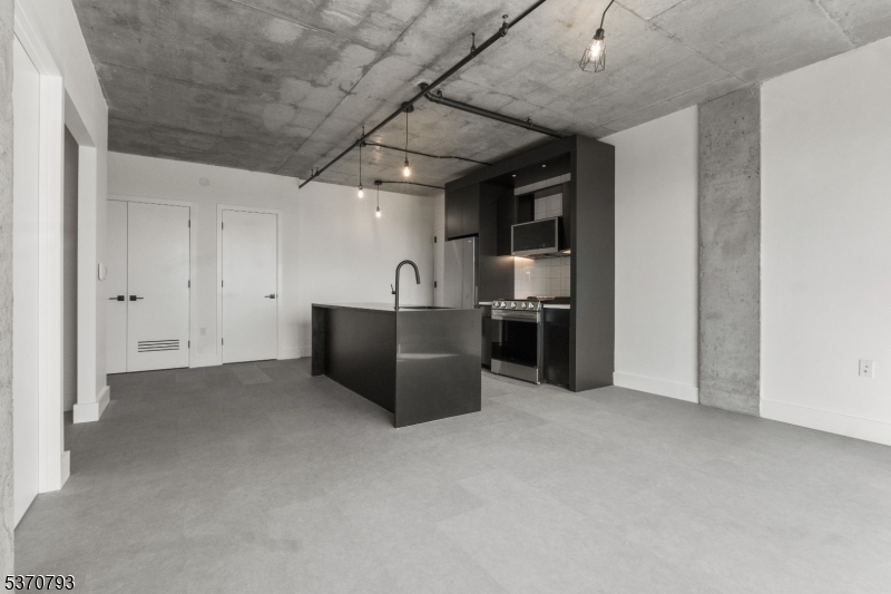 65 McWhorter Street, Unit 705 Newark, NJ 07105 - Photo 11 of 28 a kitchen with stainless steel appliances a refrigerator and a sink