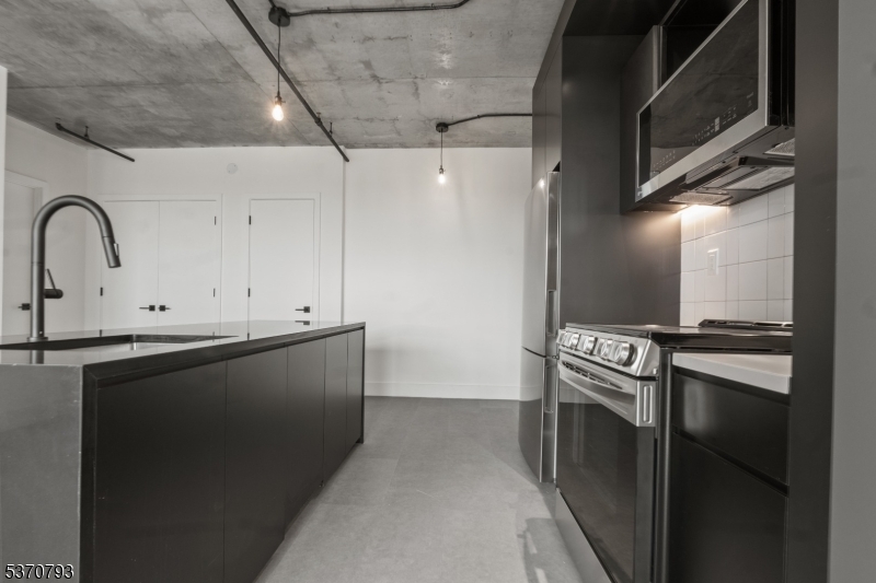 65 McWhorter Street, Unit 705 Newark, NJ 07105 - Photo 12 of 28 a view of a kitchen with wooden floor
