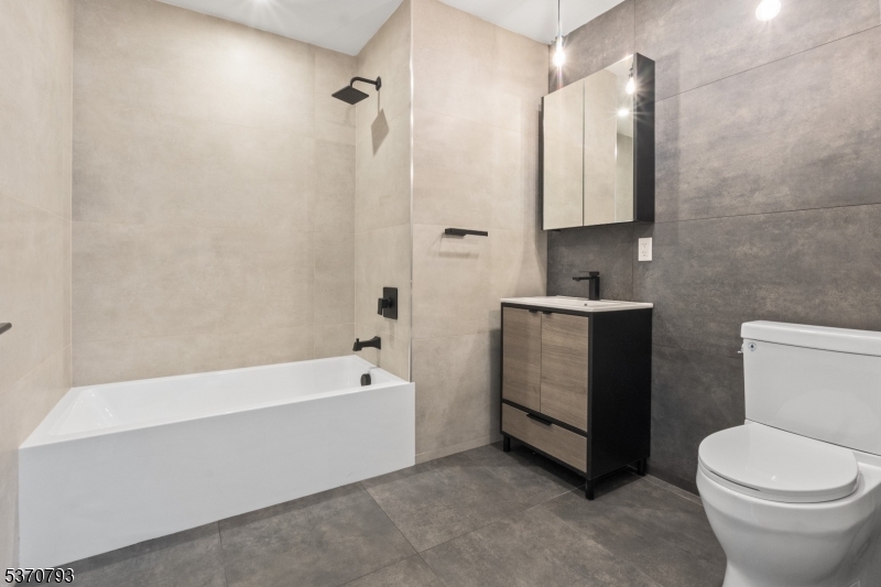 65 McWhorter Street, Unit 705 Newark, NJ 07105 - Photo 18 of 28 a bathroom with a sink a toilet and bathtub