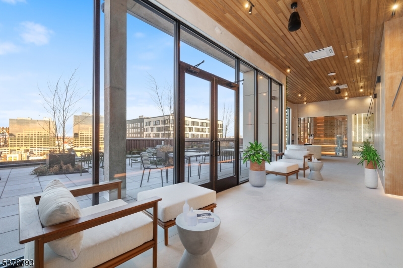65 McWhorter Street, Unit 705 Newark, NJ 07105 - Photo 2 of 28 a living room with furniture and a floor to ceiling window