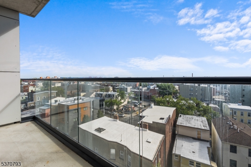 65 McWhorter Street, Unit 705 Newark, NJ 07105 - Photo 22 of 28 a view of a balcony with two chairs and a table