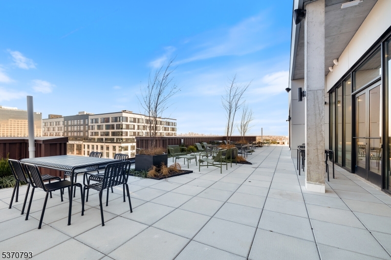 65 McWhorter Street, Unit 705 Newark, NJ 07105 - Photo 28 of 28 a view of balcony with chairs and bench