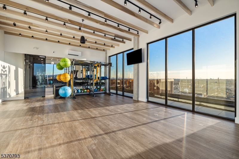 65 McWhorter Street, Unit 705 Newark, NJ 07105 - Photo 6 of 28 a view of a room with gym equipment