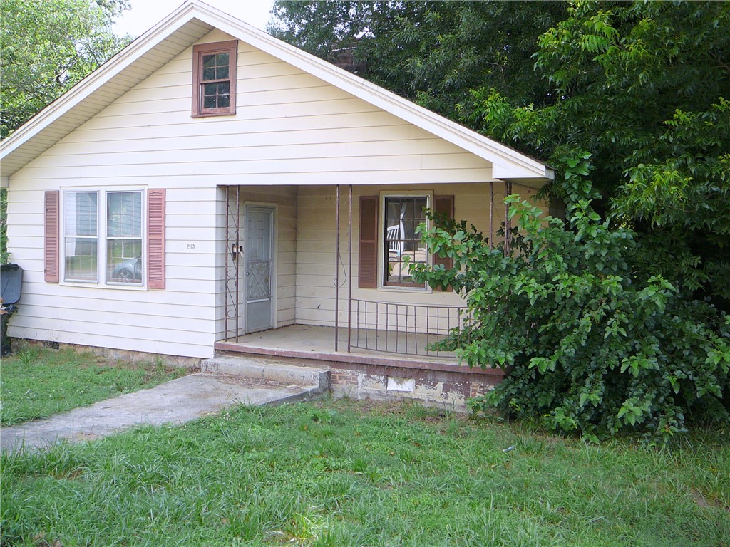 213 K Street Anderson, SC 29625 - Photo 2 of 8 A classic front porch welcomes you to this home with well-maintained exterior siding.