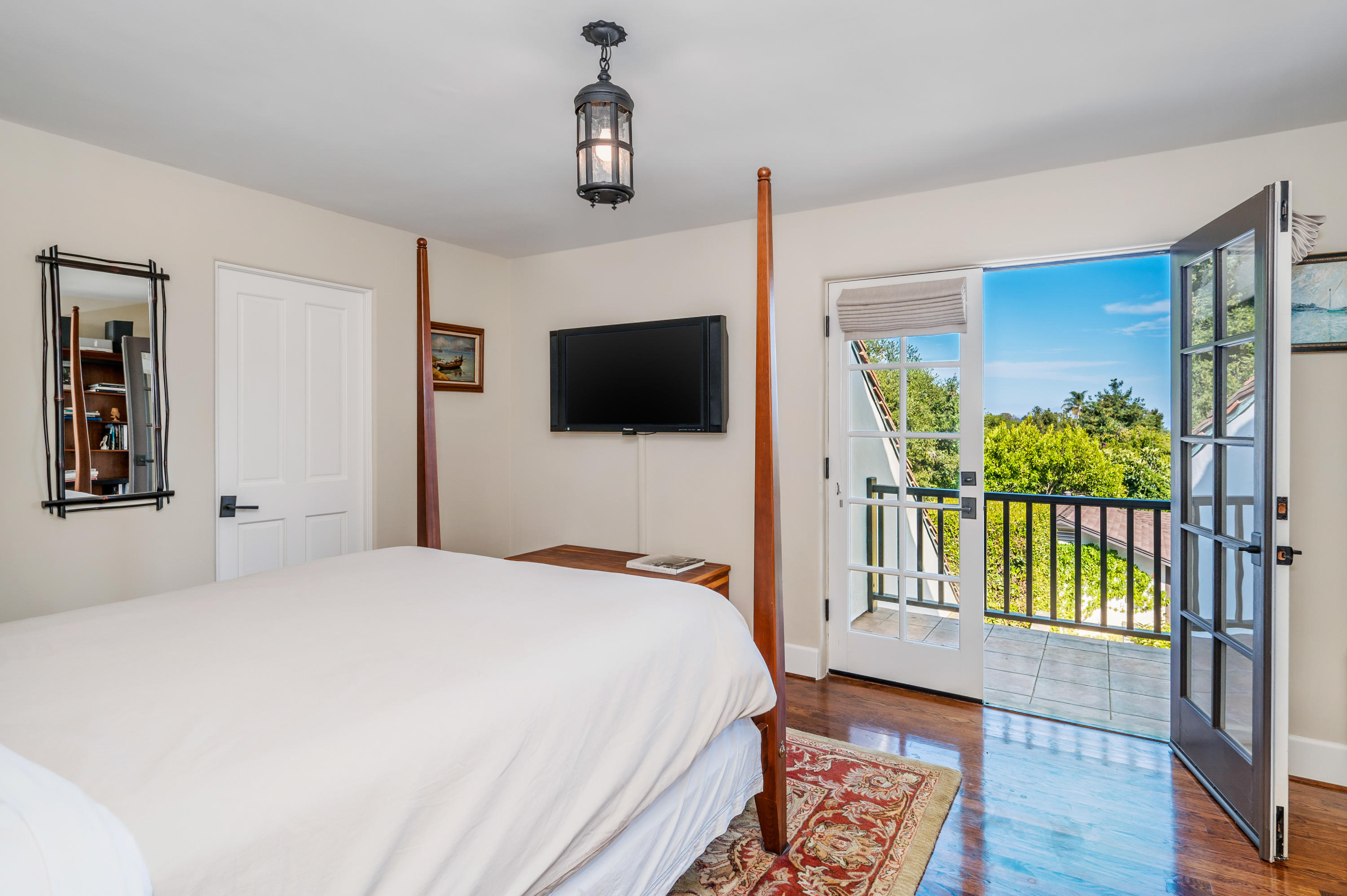 1321 School House Road Montecito, CA 93108 - Photo 14 of 34 a bedroom with a bed and a flat screen tv