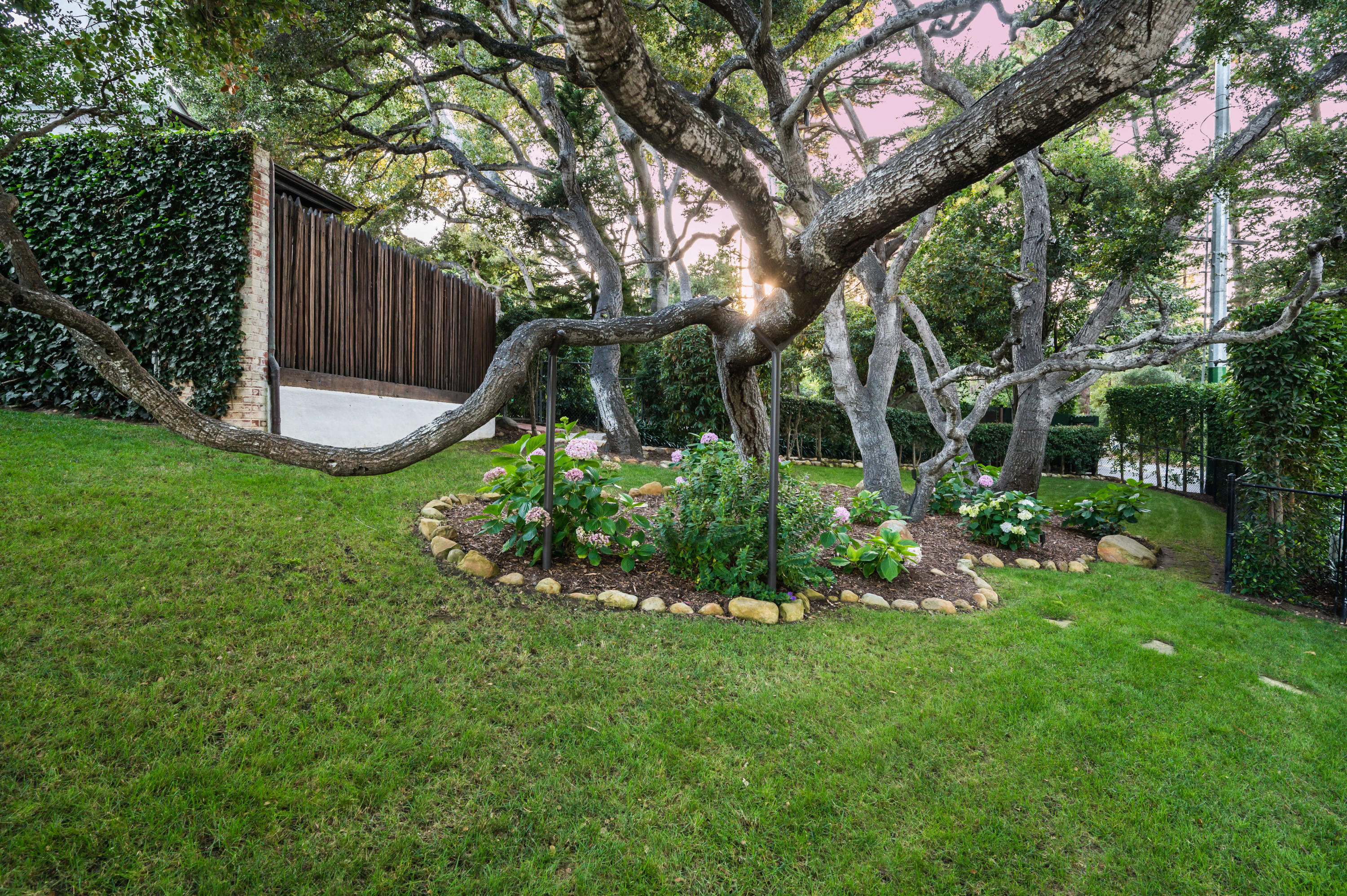 1321 School House Road Montecito, CA 93108 - Photo 21 of 34 a garden with trees in front of it
