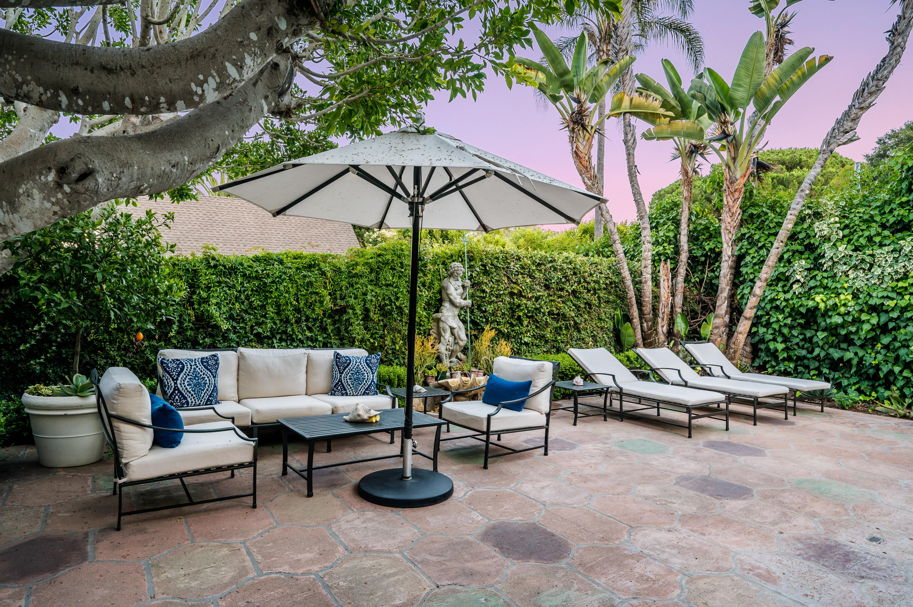 1321 School House Road Montecito, CA 93108 - Photo 24 of 34 a view of a patio with a table and chairs under an umbrella