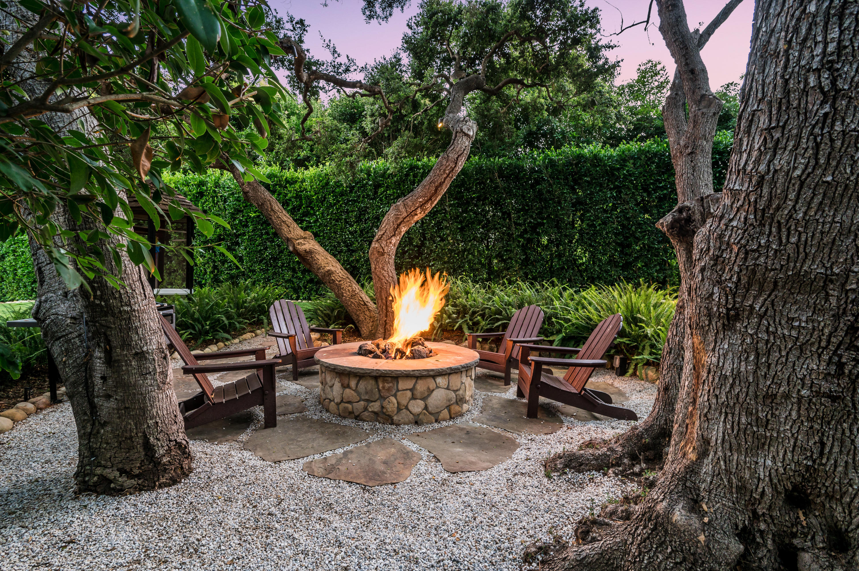 1321 School House Road Montecito, CA 93108 - Photo 28 of 34 a view of a backyard with table and chairs potted plants and large tree