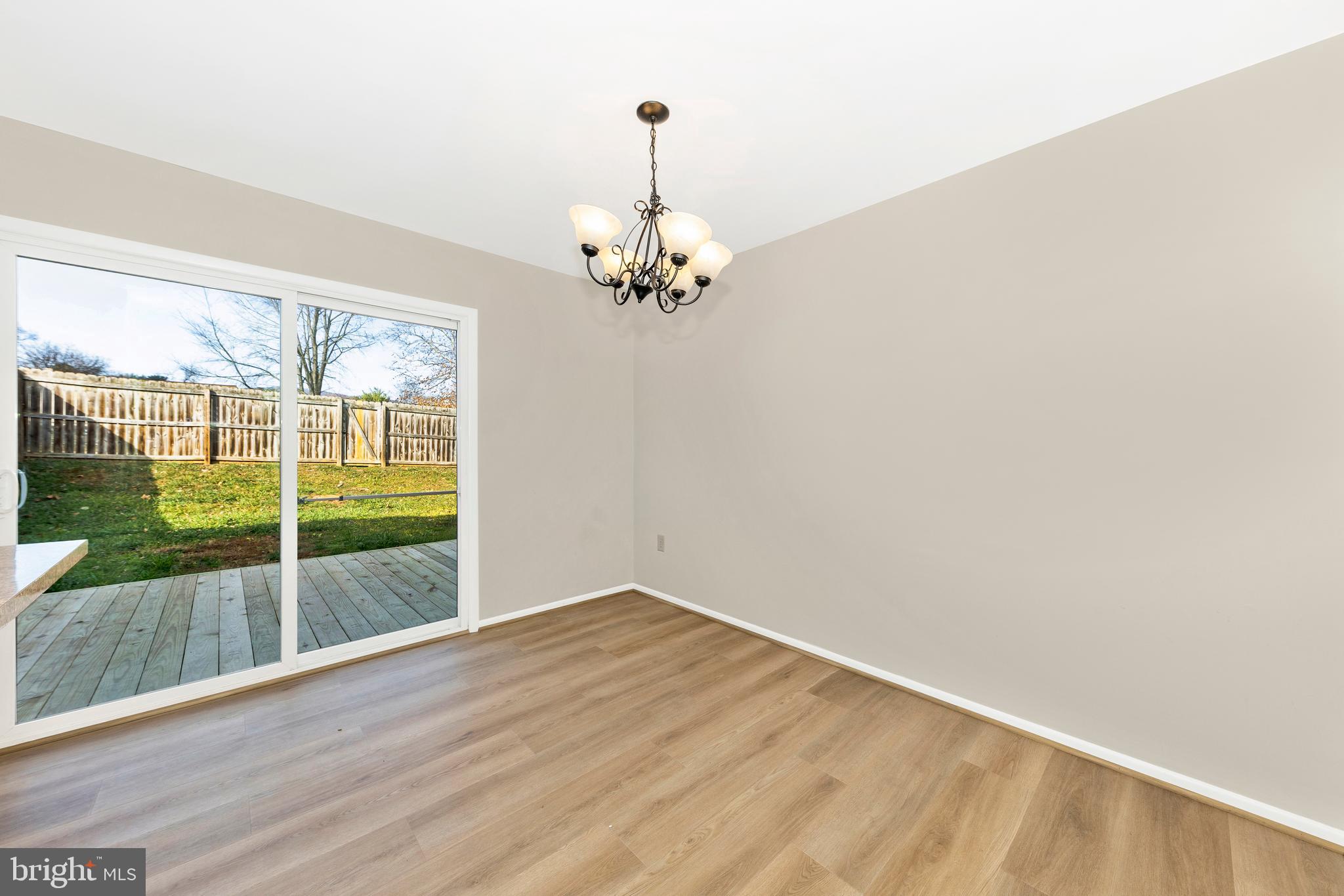 167 Stonegate Drive Frederick, MD 21702 - Photo 11 of 48 a view of a room with wooden floor a ceiling fan and front door