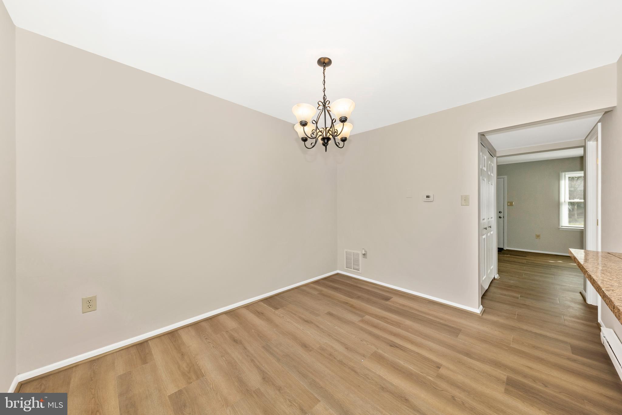 167 Stonegate Drive Frederick, MD 21702 - Photo 14 of 48 a view of a room with wooden floor and chandelier