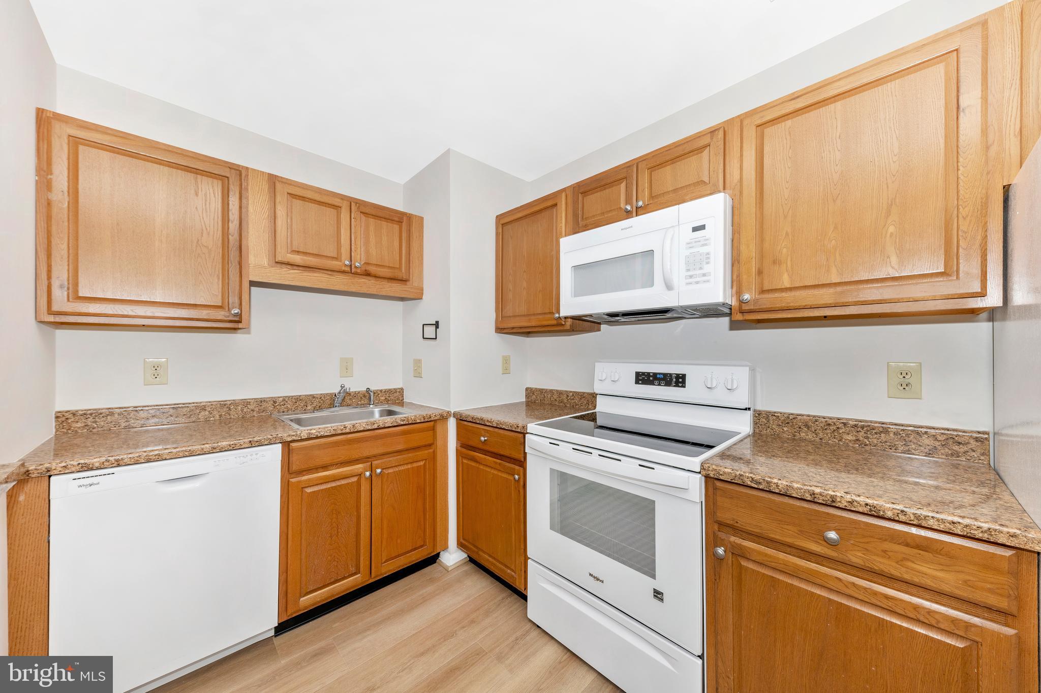 167 Stonegate Drive Frederick, MD 21702 - Photo 16 of 48 a kitchen with stainless steel appliances granite countertop a stove and a microwave