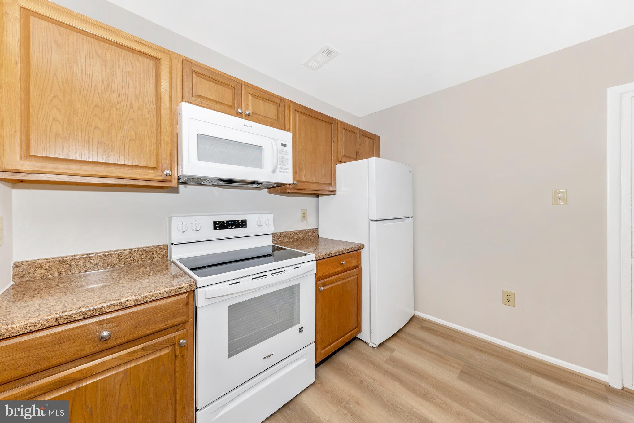 167 Stonegate Drive Frederick, MD 21702 - Photo 17 of 48 a kitchen with granite countertop white cabinets and white appliances