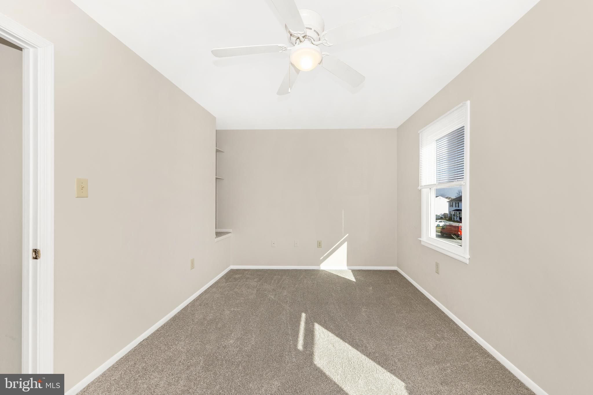 167 Stonegate Drive Frederick, MD 21702 - Photo 23 of 48 an empty room with windows and ceiling fan