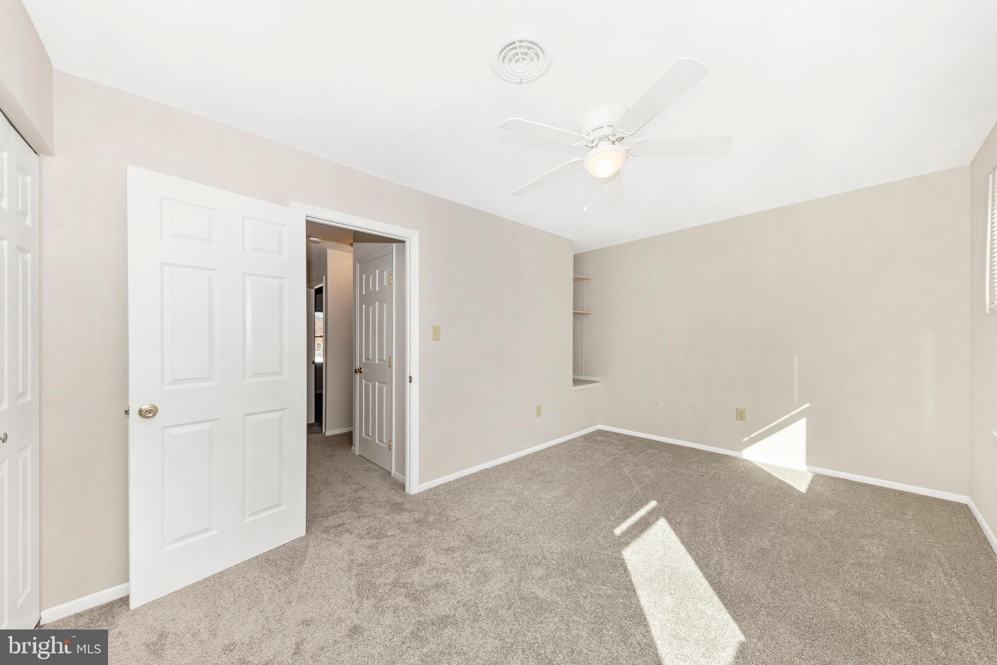 167 Stonegate Drive Frederick, MD 21702 - Photo 24 of 48 an empty room with a ceiling fan and a window