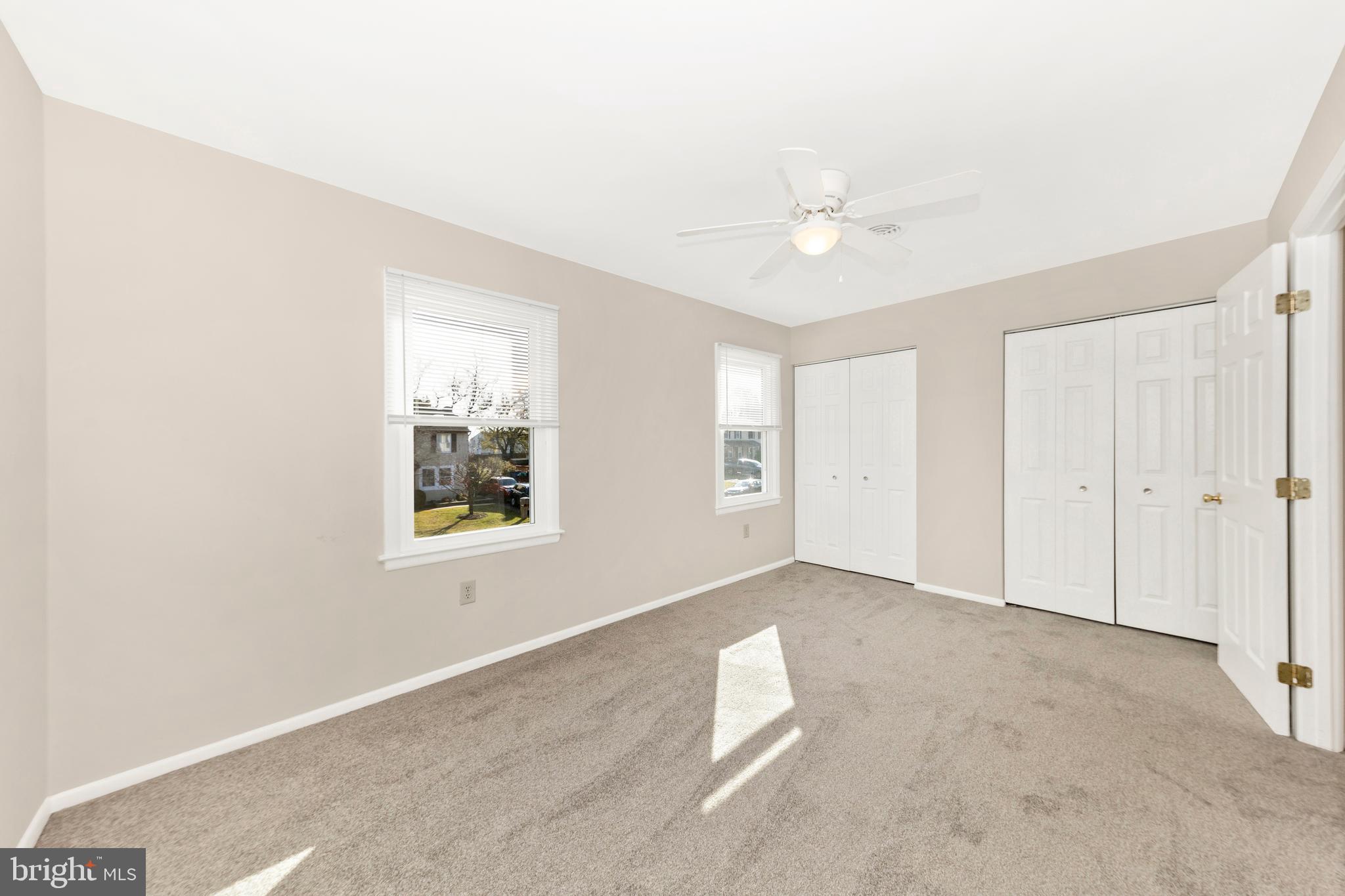 167 Stonegate Drive Frederick, MD 21702 - Photo 26 of 48 an empty room with windows and ceiling fan