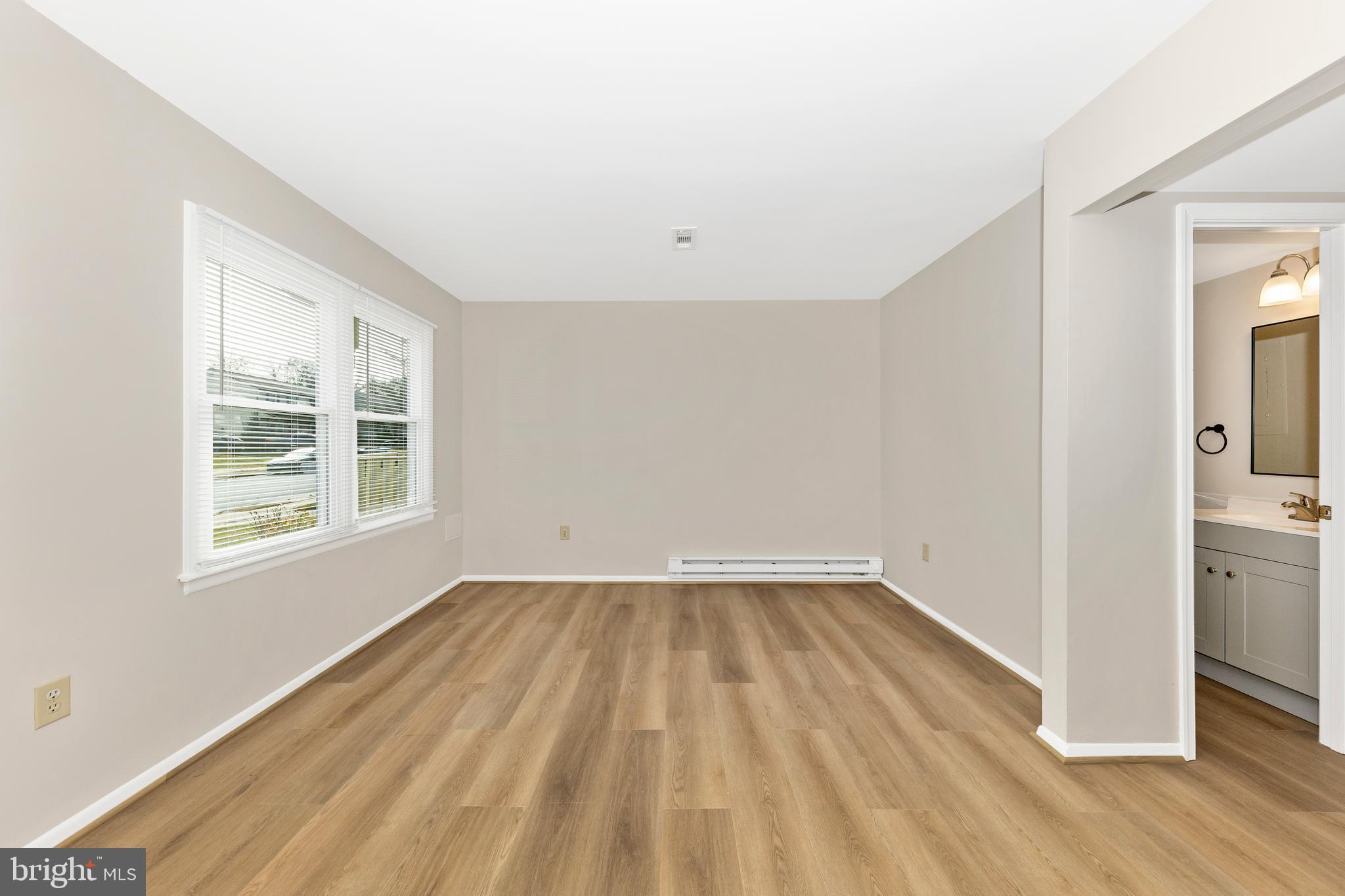 167 Stonegate Drive Frederick, MD 21702 - Photo 6 of 48 a view of an empty room with wooden floor and a window