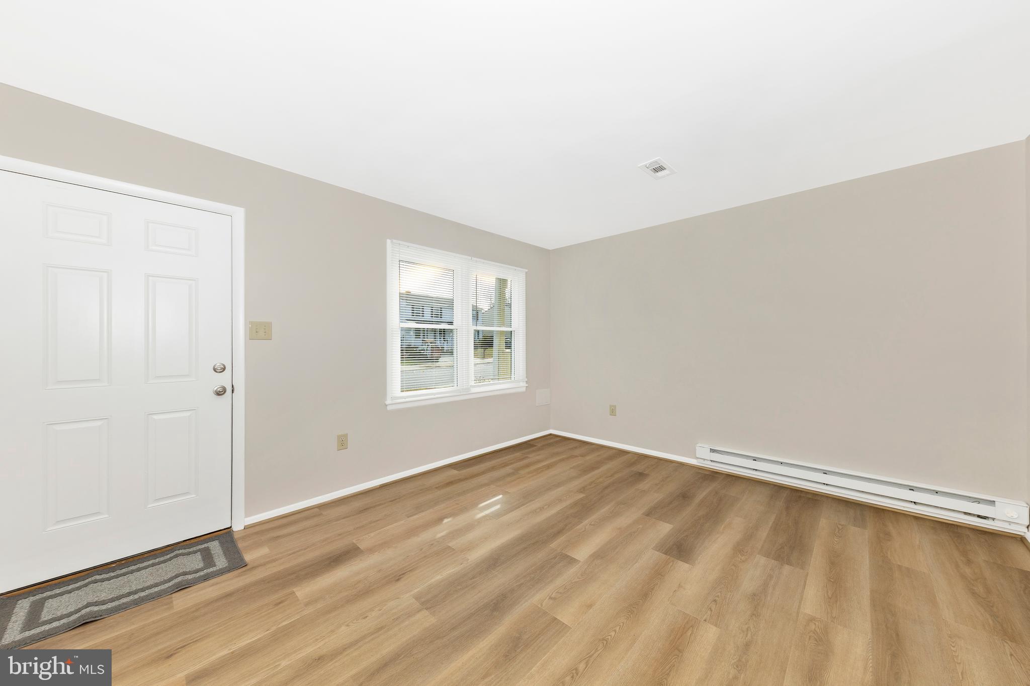 167 Stonegate Drive Frederick, MD 21702 - Photo 7 of 48 an empty room with wooden floor and windows
