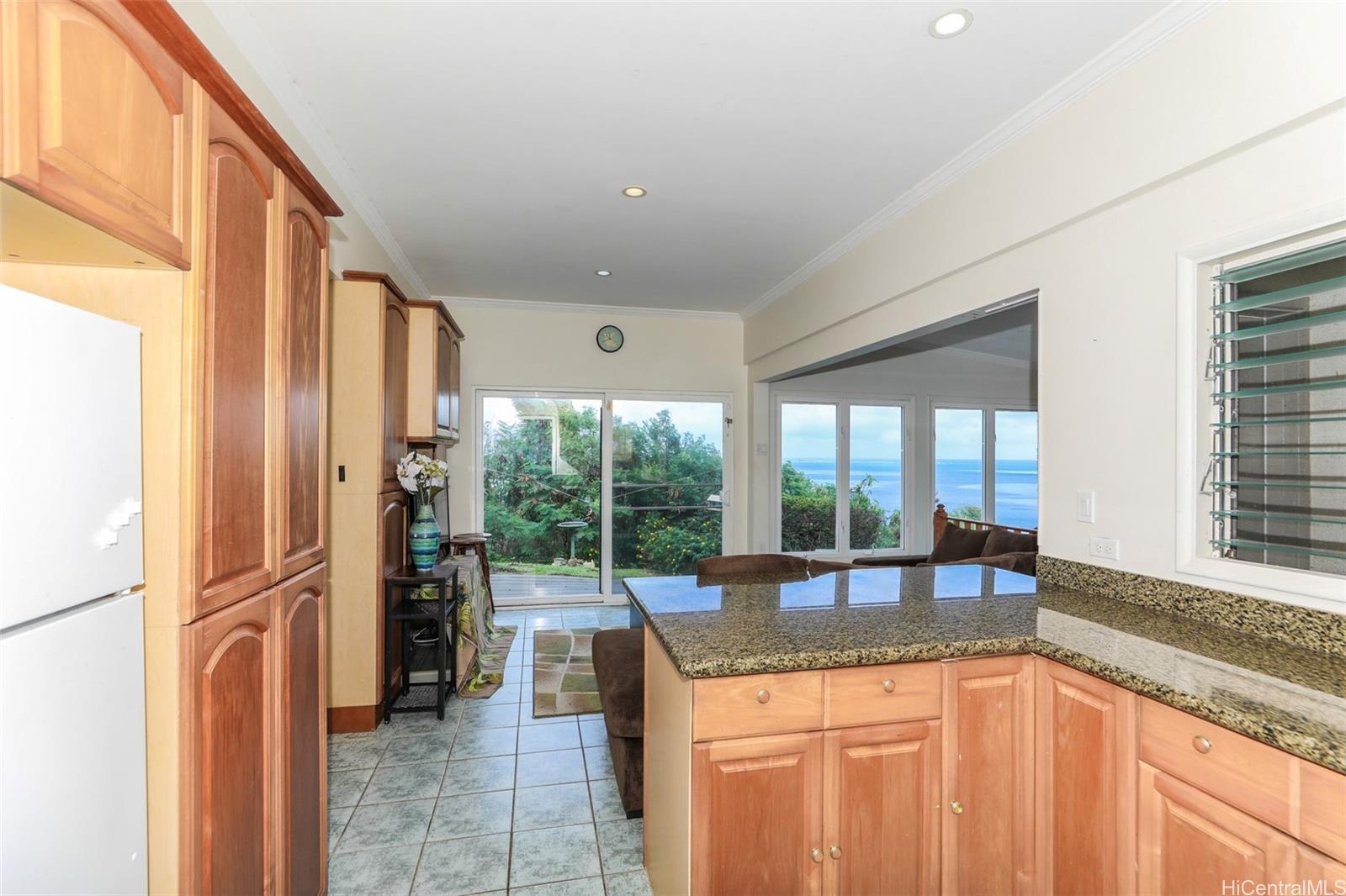45-001 Lilipuna Road, Unit B Kaneohe, HI 96744 - Photo 14 of 22 a kitchen with granite countertop a sink and a refrigerator