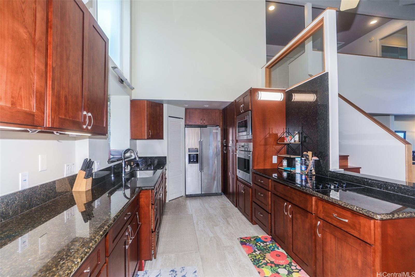45-001 Lilipuna Road, Unit B Kaneohe, HI 96744 - Photo 7 of 22 a kitchen with stainless steel appliances granite countertop a sink stove and cabinets