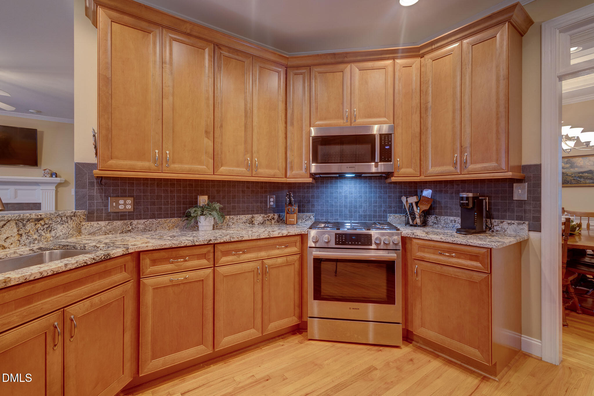 1116 Neuse Ridge Drive Clayton, NC 27527 - Photo 13 of 39 a kitchen with stainless steel appliances granite countertop a stove a sink and dishwasher with white cabinets