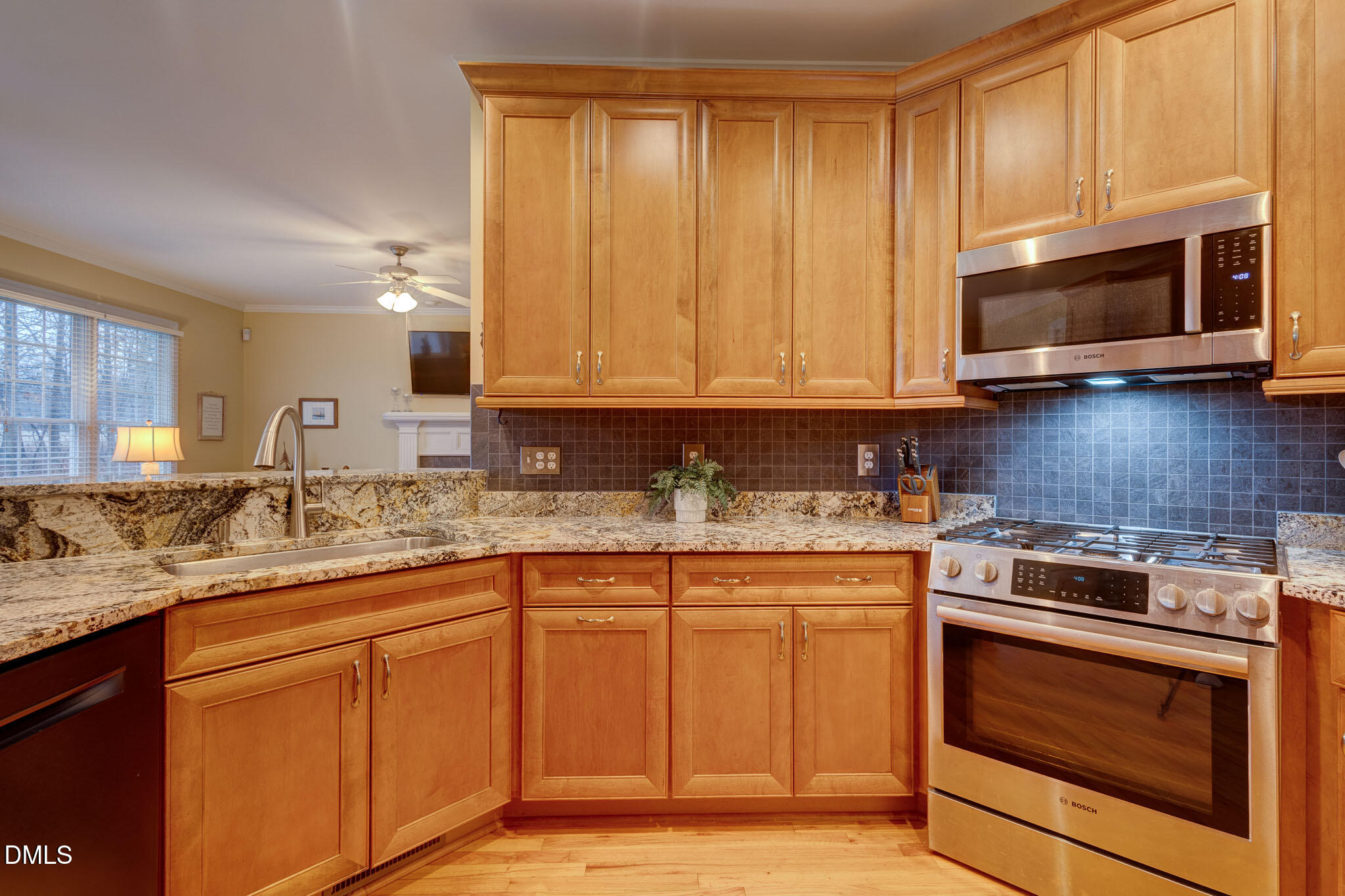 1116 Neuse Ridge Drive Clayton, NC 27527 - Photo 15 of 39 a kitchen with stainless steel appliances granite countertop a sink stove and microwave