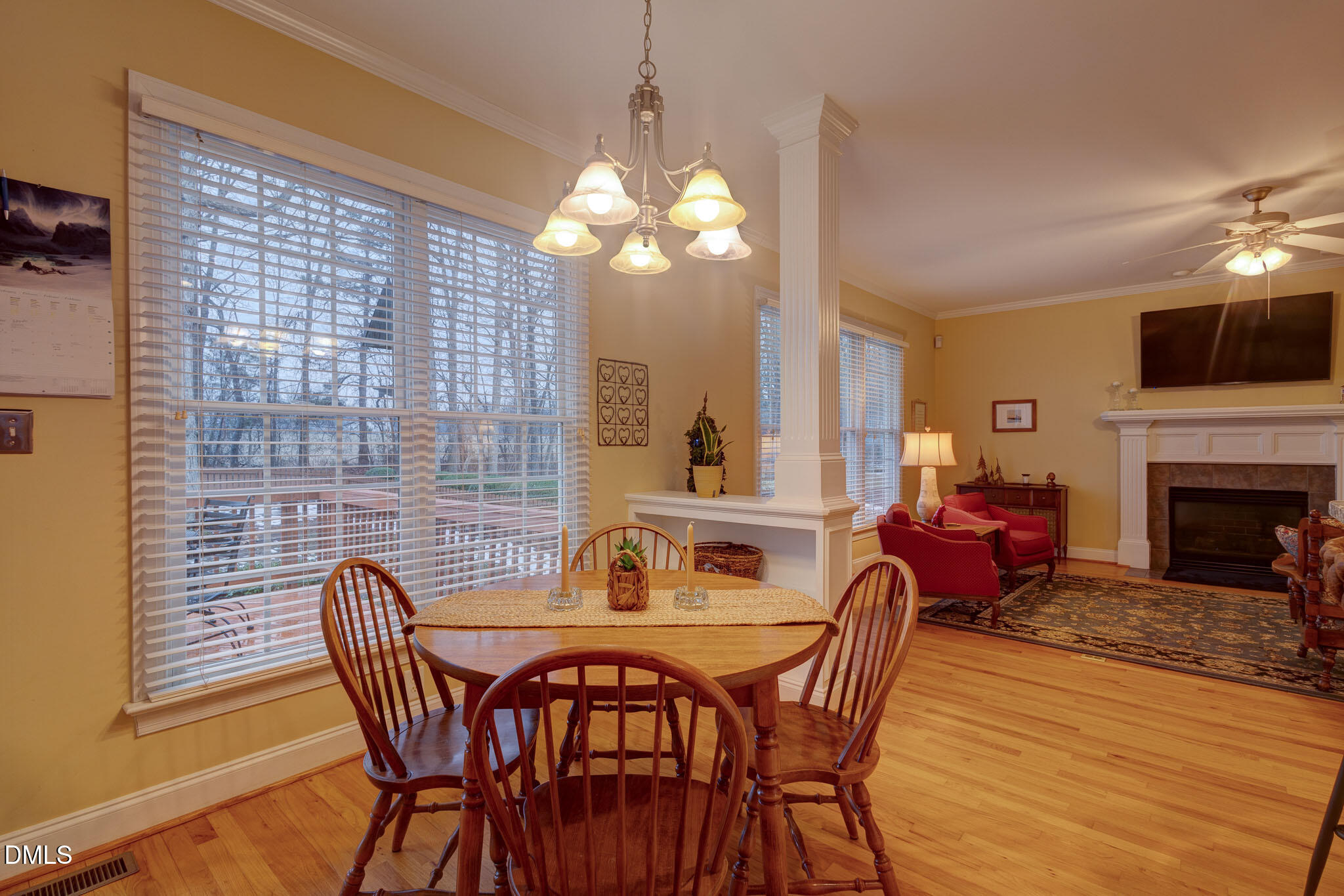 1116 Neuse Ridge Drive Clayton, NC 27527 - Photo 19 of 39 a dining room with furniture a chandelier and wooden floor