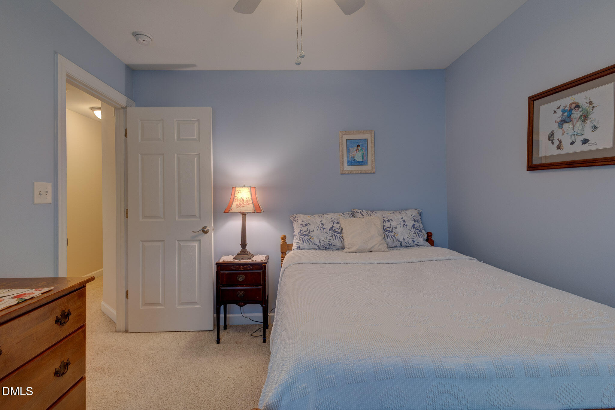 1116 Neuse Ridge Drive Clayton, NC 27527 - Photo 22 of 39 a bedroom with a bed and a lamp on desk