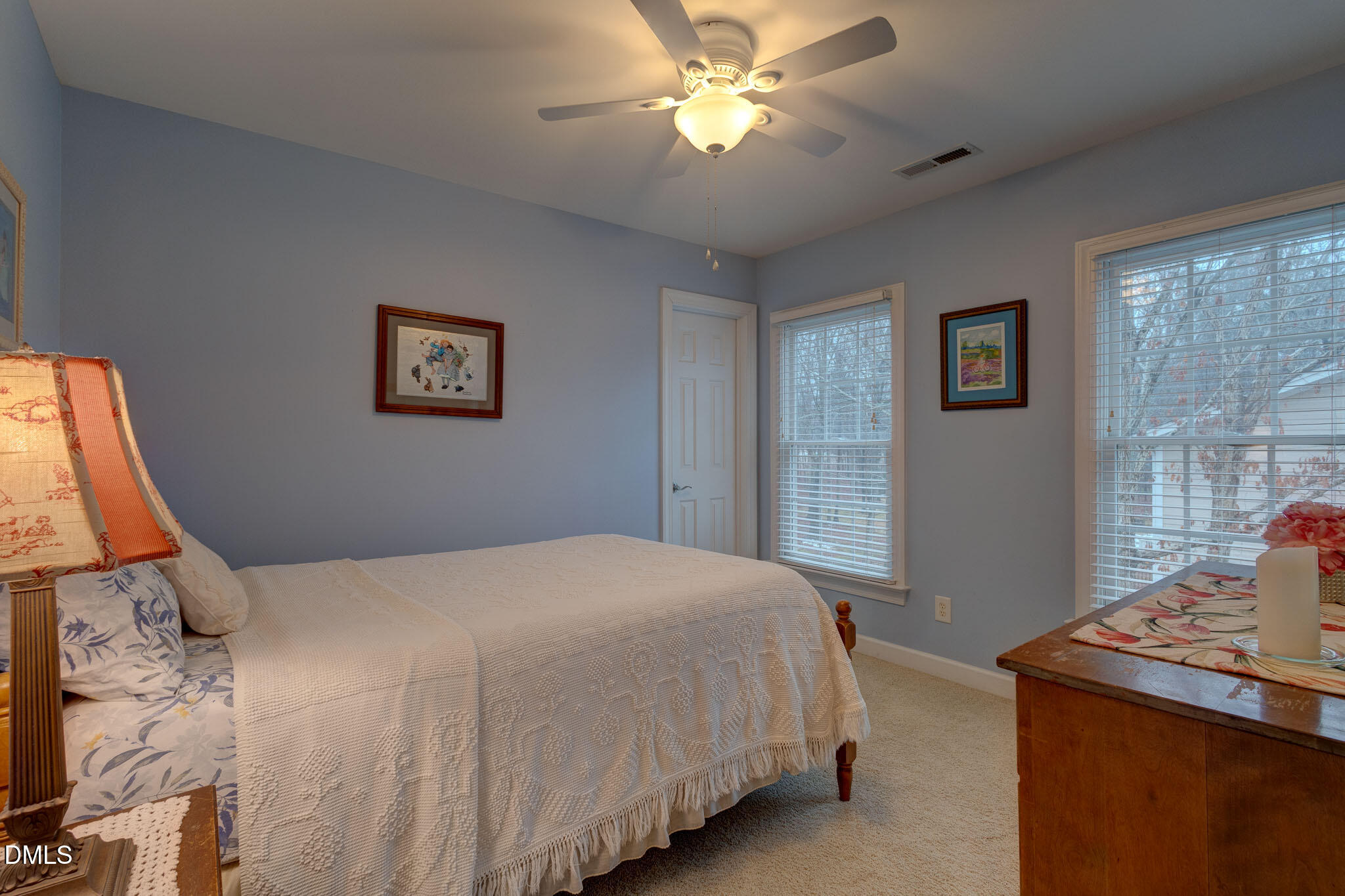 1116 Neuse Ridge Drive Clayton, NC 27527 - Photo 23 of 39 a bedroom with a bed and a chandelier