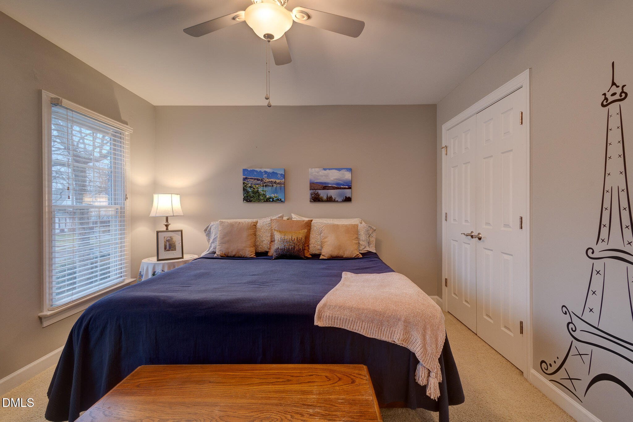 1116 Neuse Ridge Drive Clayton, NC 27527 - Photo 25 of 39 a bedroom with a large bed and a chandelier