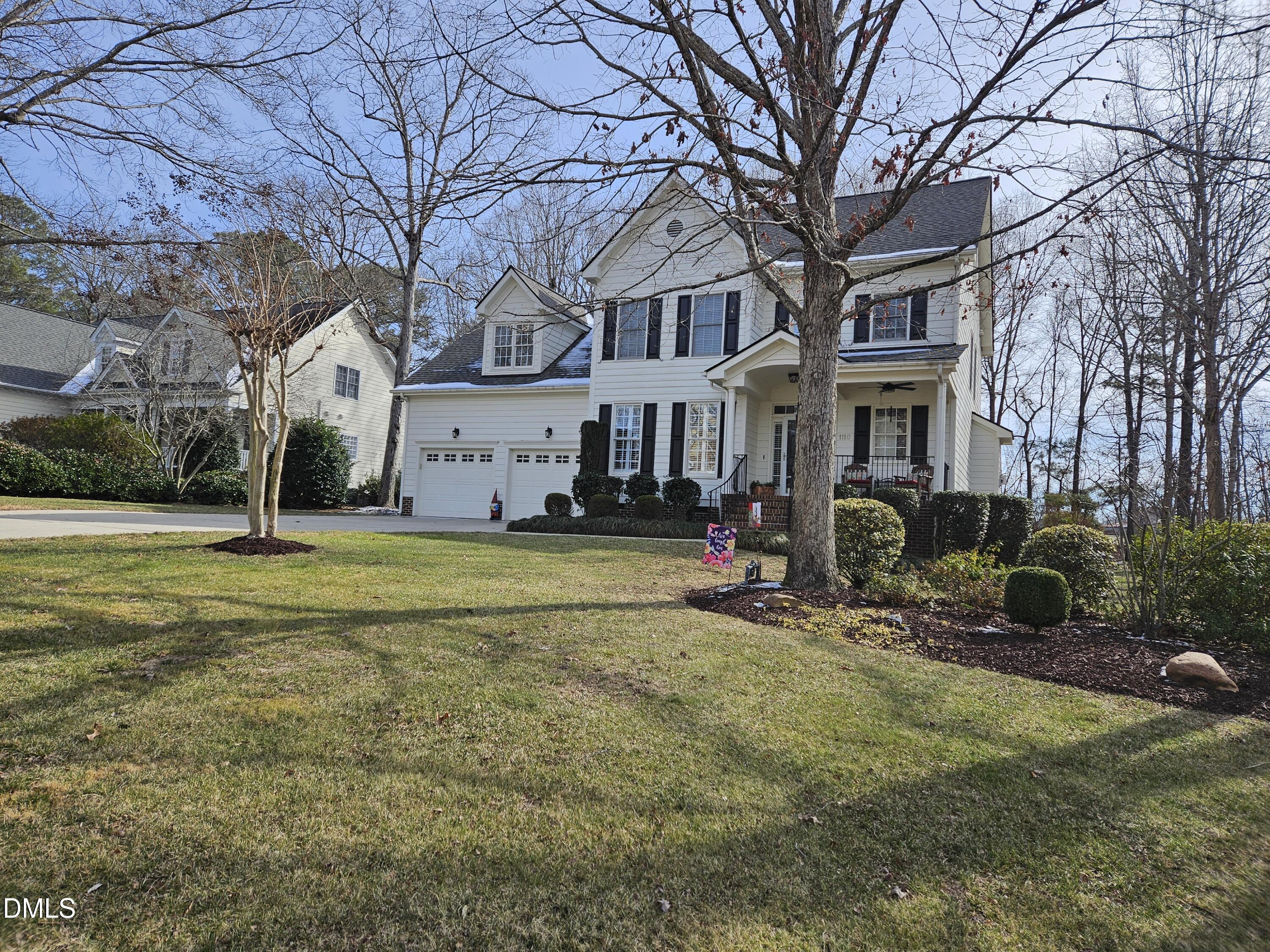 1116 Neuse Ridge Drive Clayton, NC 27527 - Photo 2 of 39 a view of a white house with a big yard and large trees