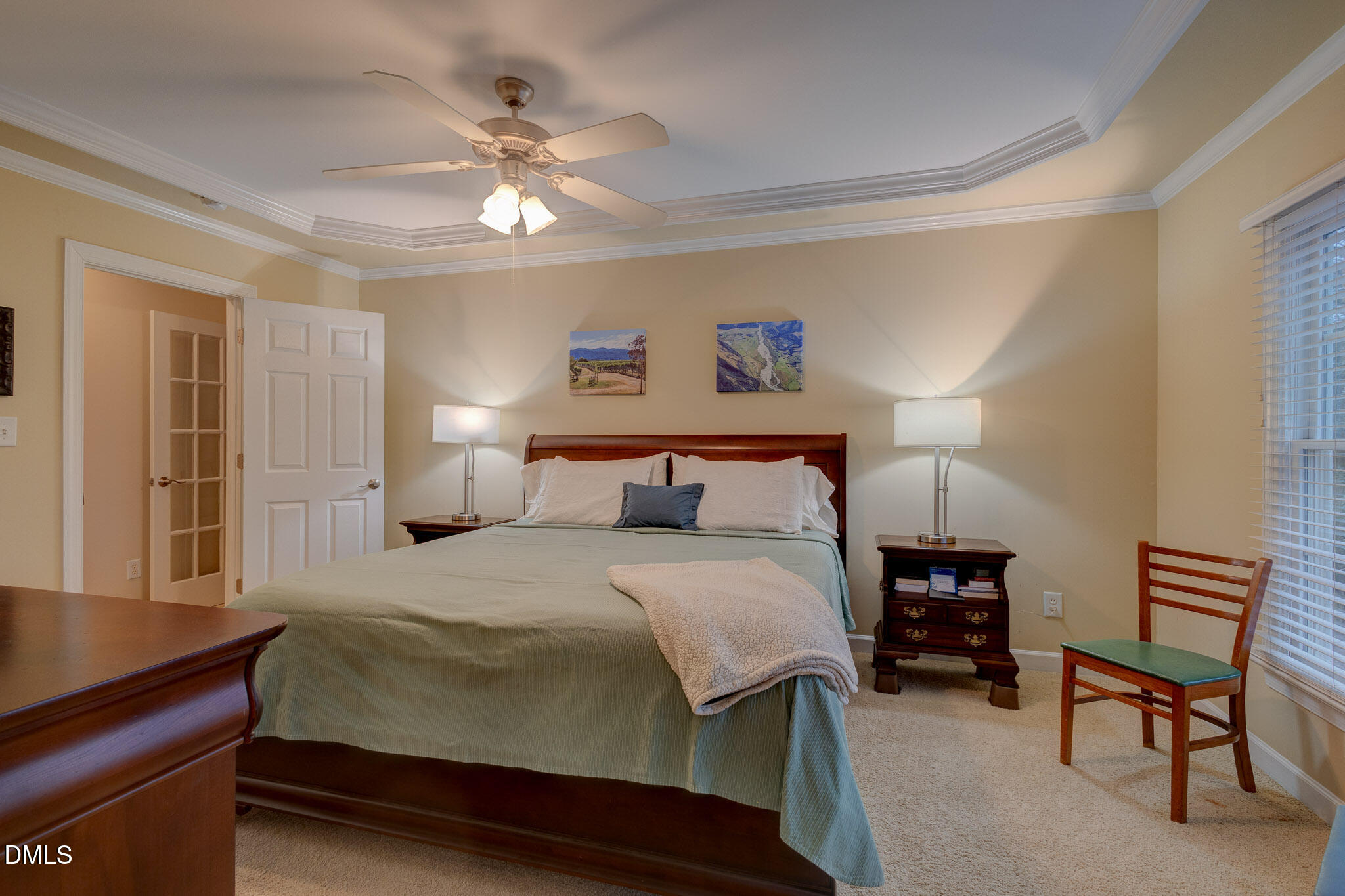1116 Neuse Ridge Drive Clayton, NC 27527 - Photo 28 of 39 a bedroom with a bed and a chandelier