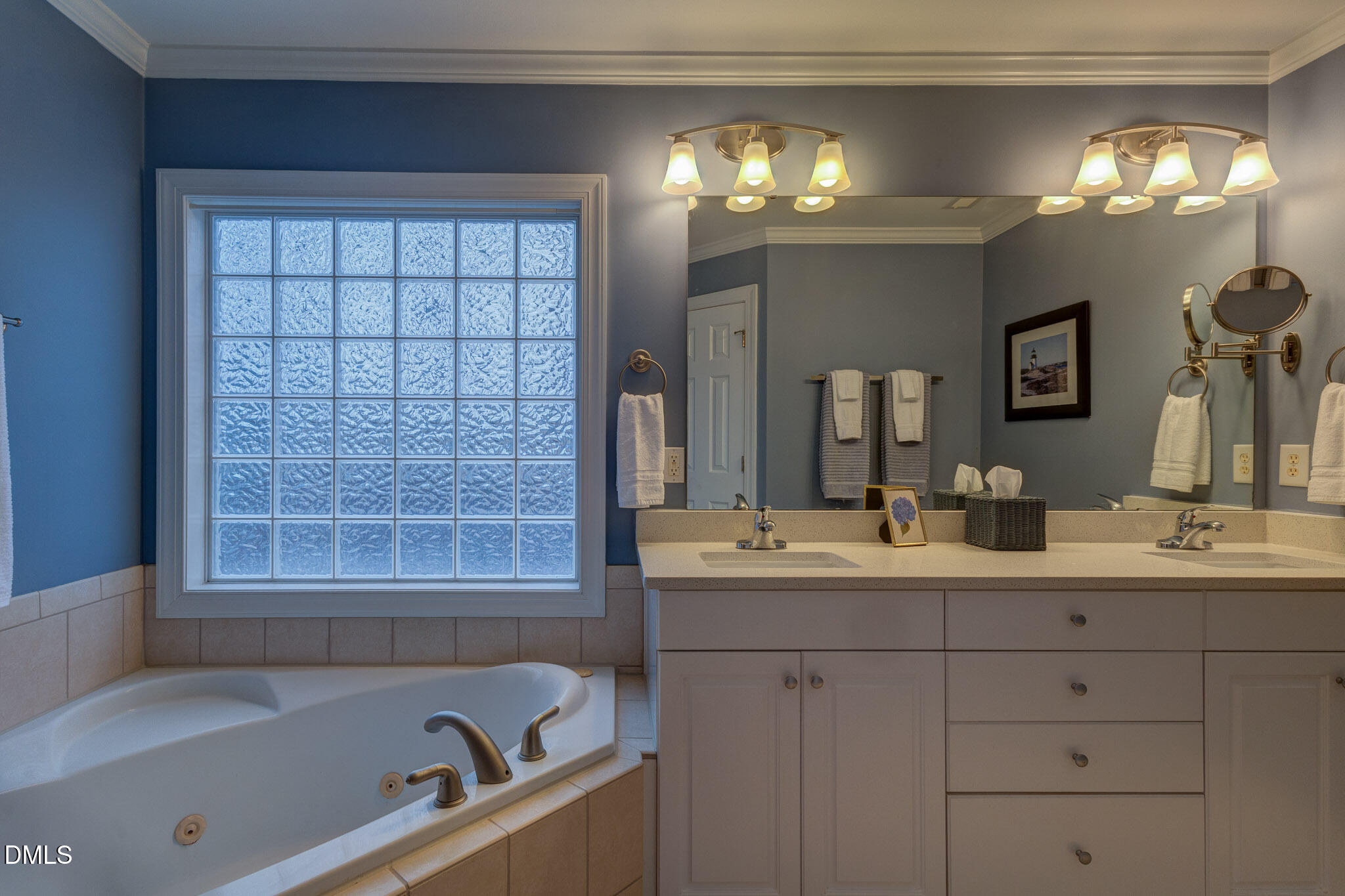1116 Neuse Ridge Drive Clayton, NC 27527 - Photo 30 of 39 a bathroom with a bathtub a sink and a mirror