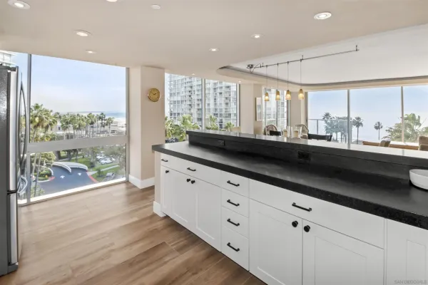 a kitchen with granite countertop a sink window and wooden floor